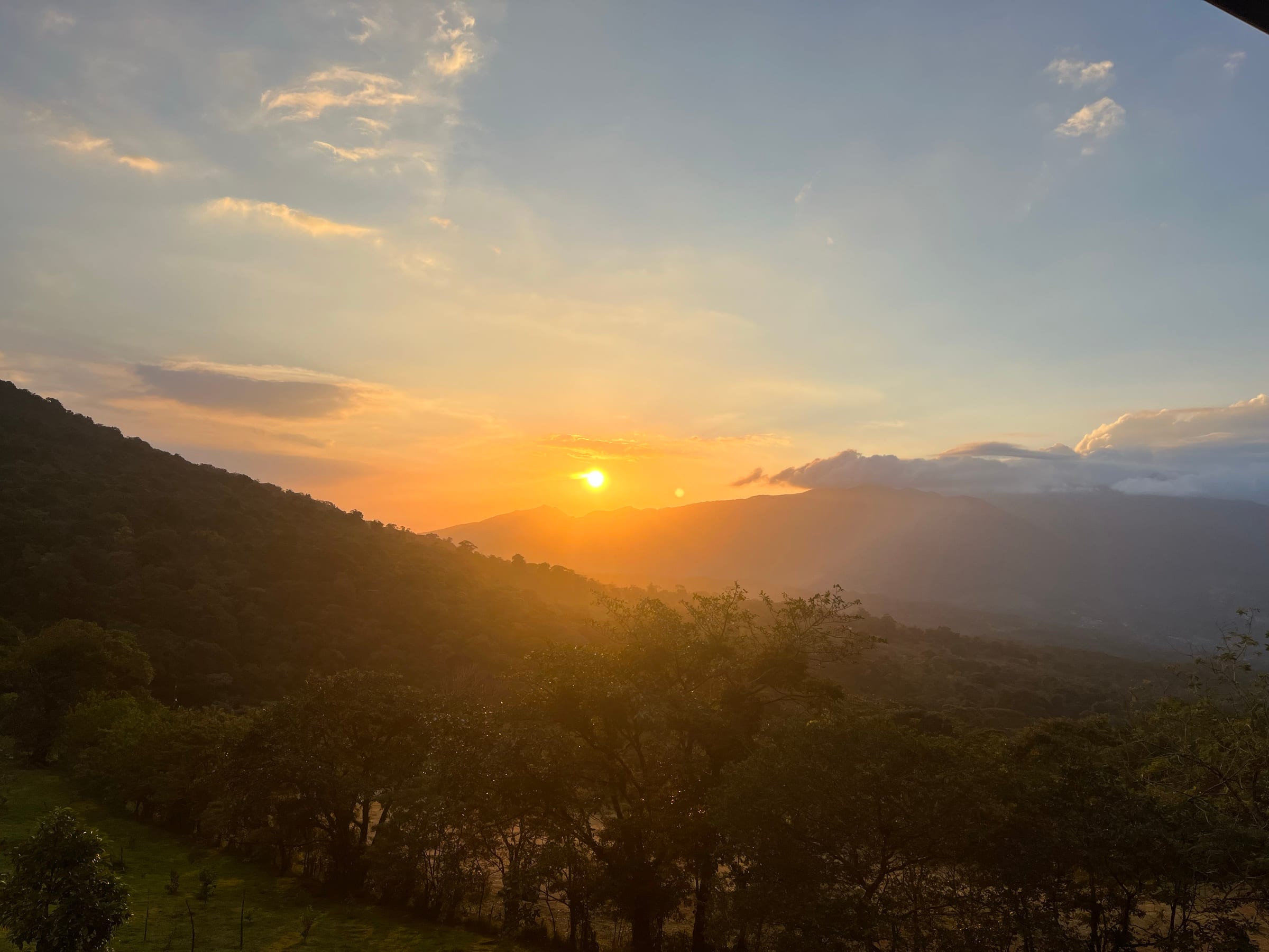 Sunset over the layered ridges seen from the property